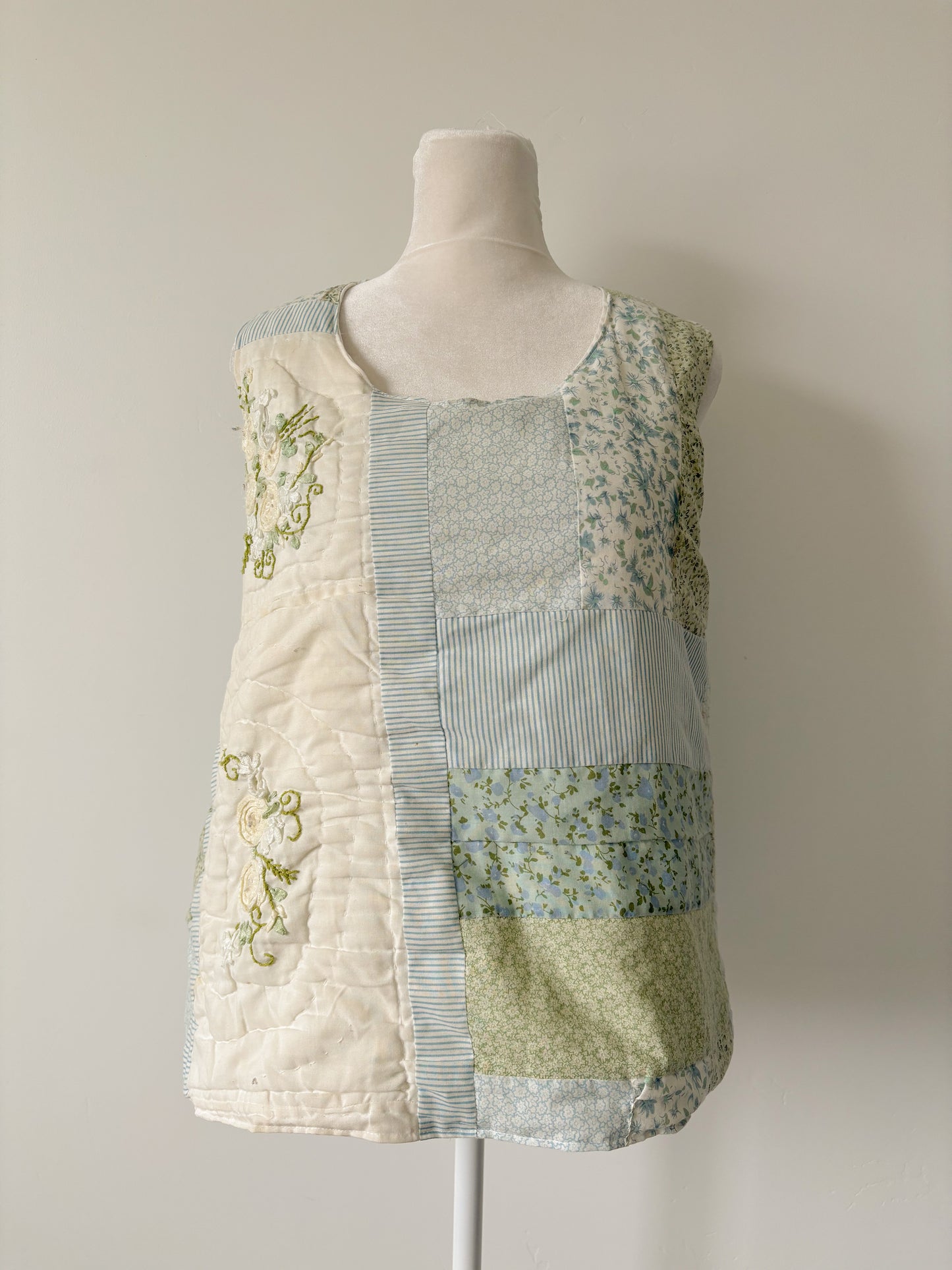 Blue and green floral quilted pullover vest