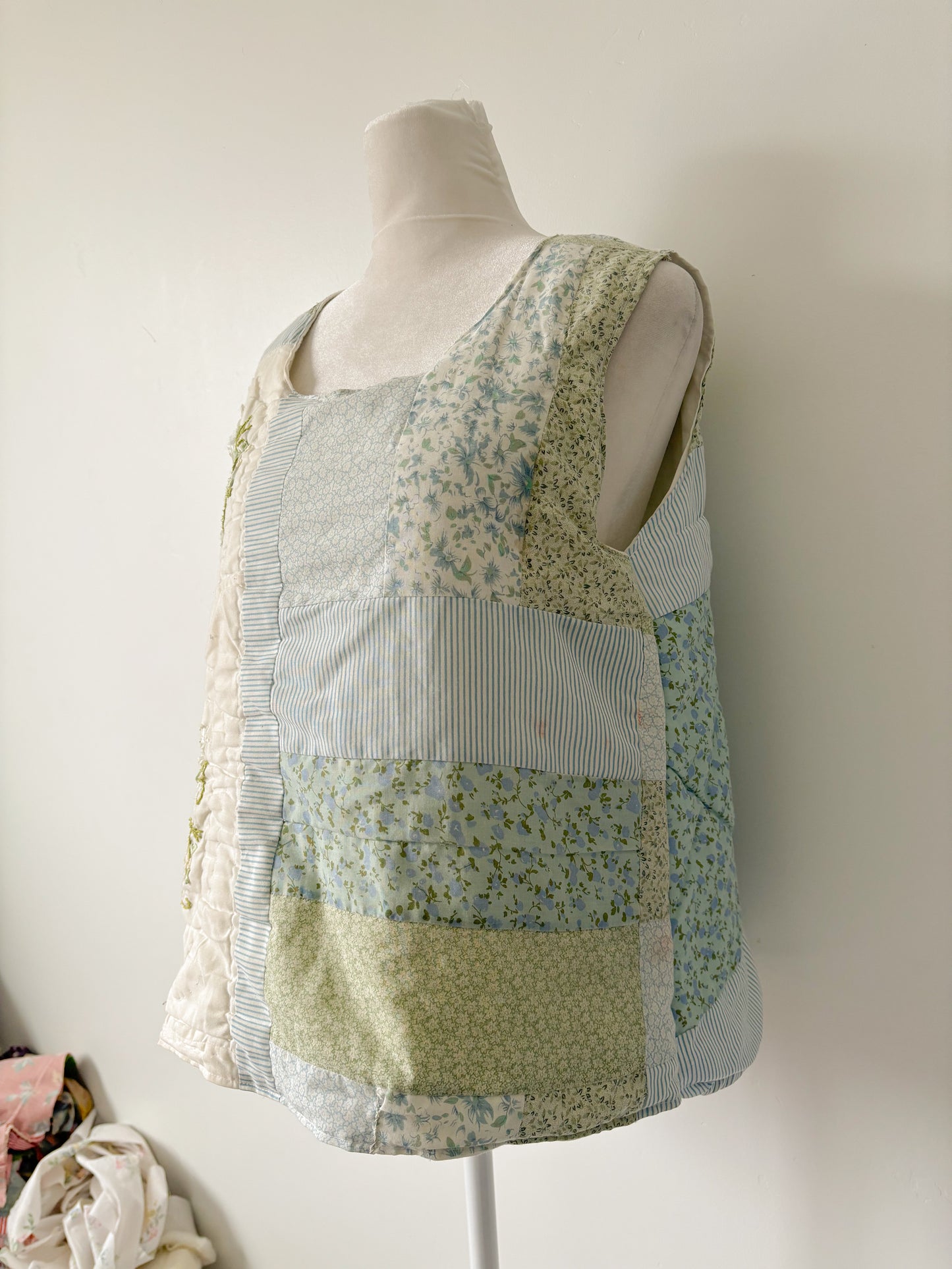 Blue and green floral quilted pullover vest